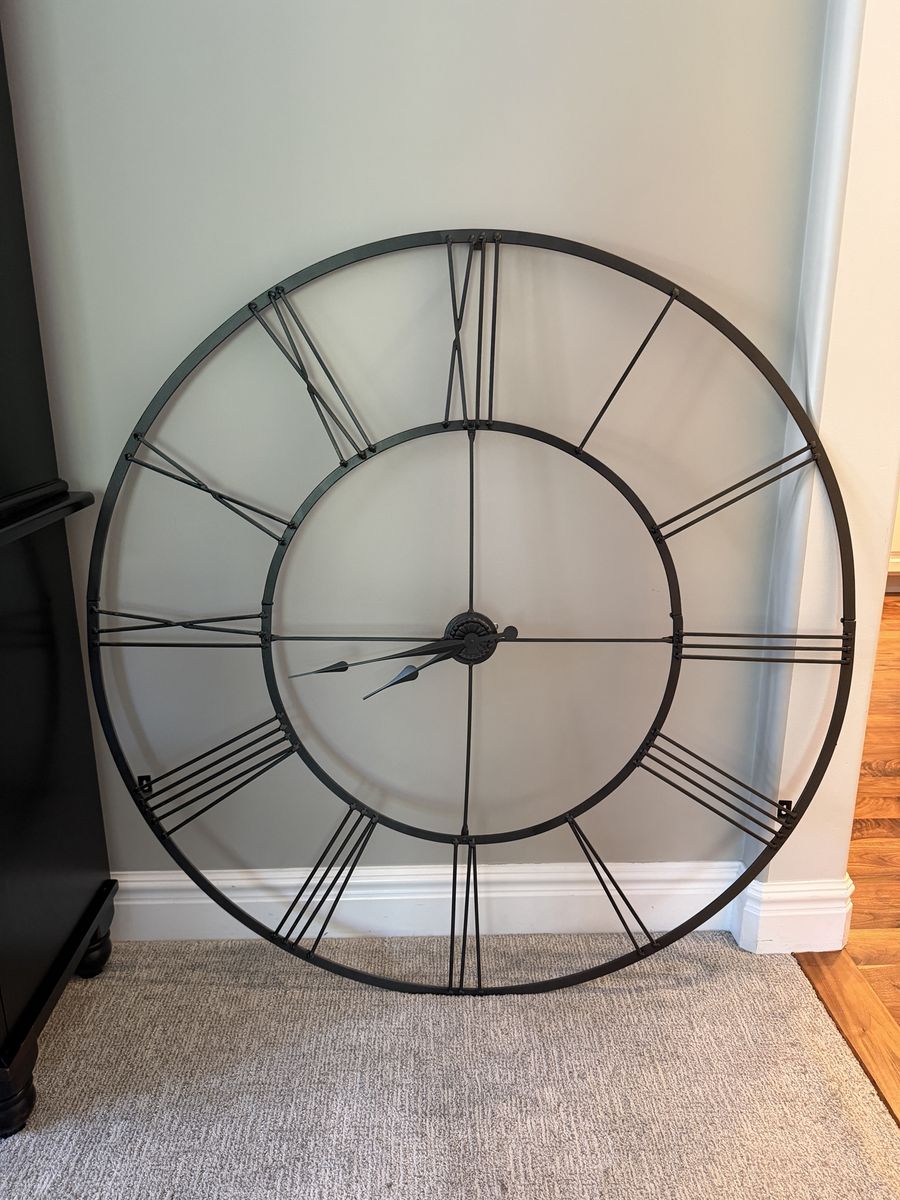 Large black metal wall clock