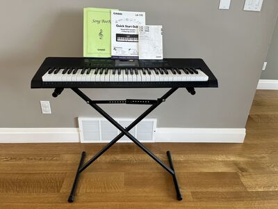 Casio LT-170 keyboard with stand, owner’s manual and music. Like new