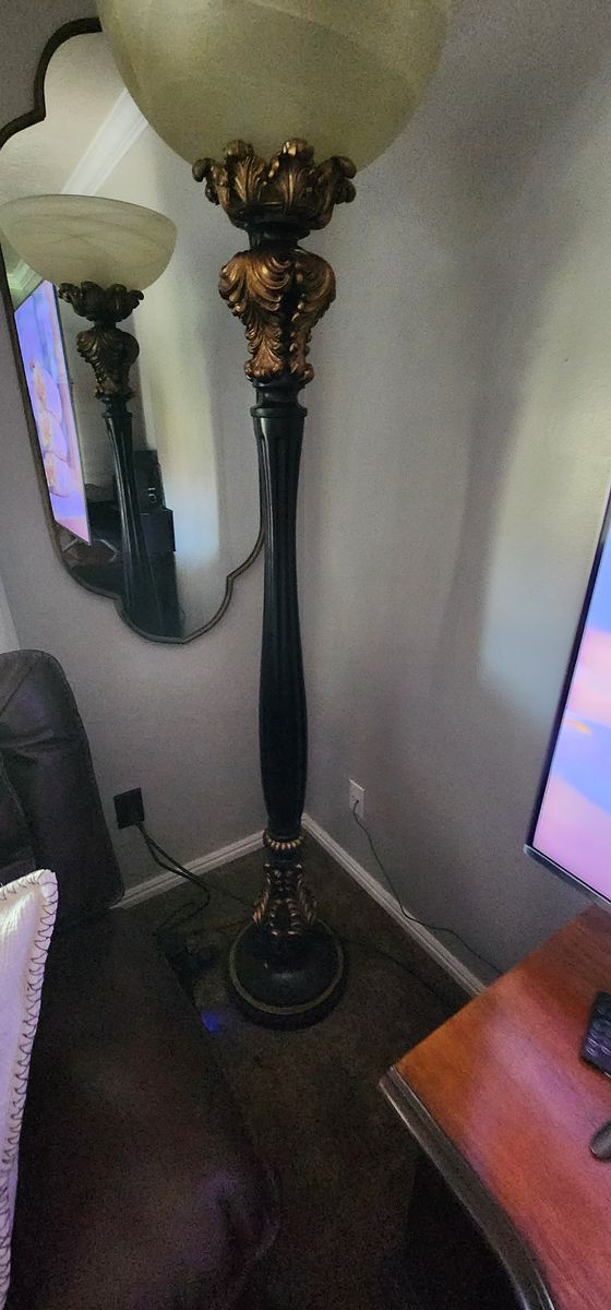 Barnes and Ivy Rita Traditional Victorian Torchiere Floor Lamp in black with gold accents and an amber glass shade.