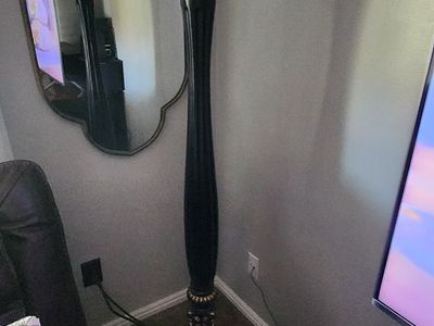 Barnes and Ivy Rita Traditional Victorian Torchiere Floor Lamp in black with gold accents and an amber glass shade.
