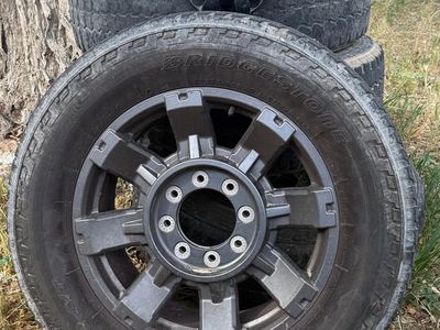 20" Dark Carbonized Gray Aluminum Sport Wheel (OEM Part Number 10485)paired with used LT275/65R20 Bridgestone Dueler A/T tires