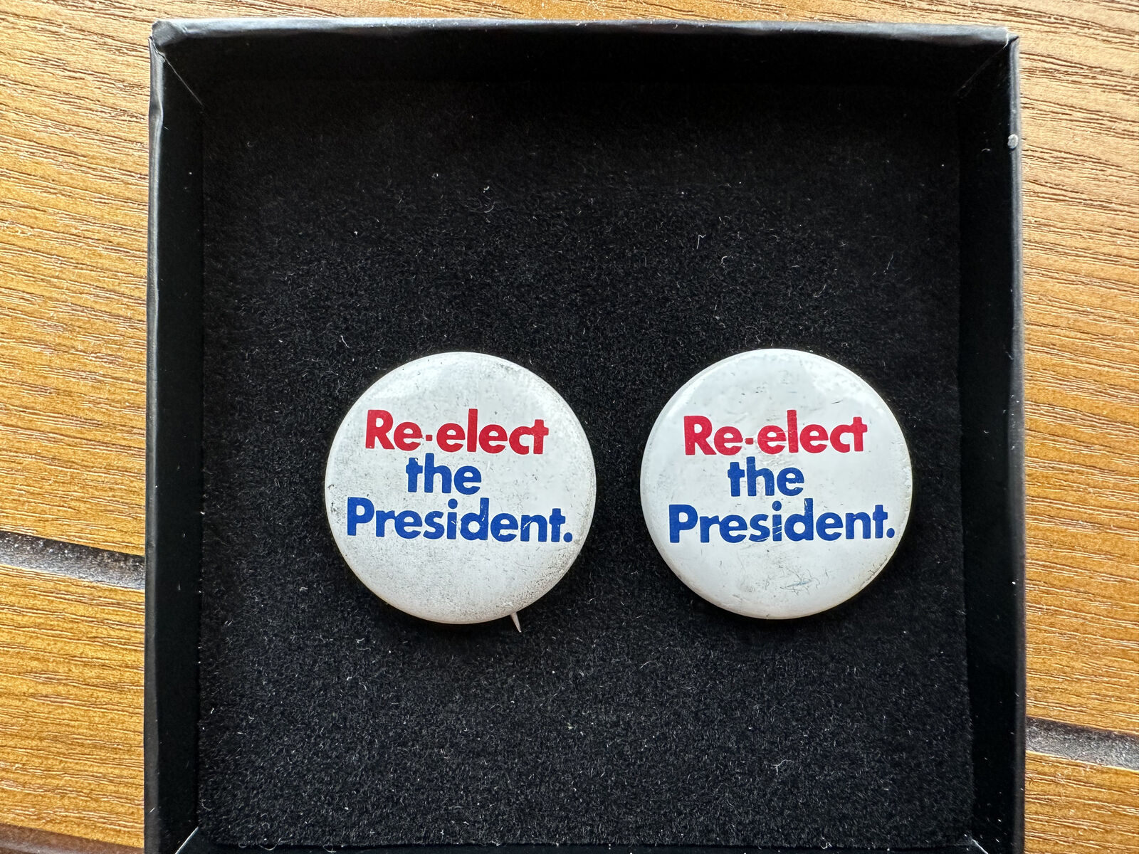 Two Vintage "Re-elect the President" Campaign Buttons from Richard Nixon's 1972 Presidential Campaign.
