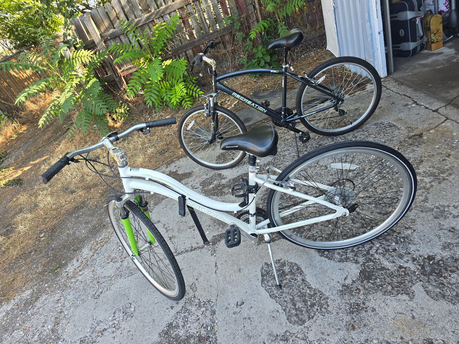 Two Bikes and two vertical rolling bike stands, Great condition