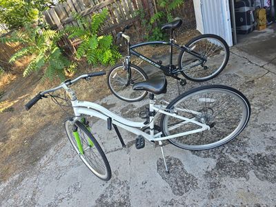 Two Bikes and two vertical rolling bike stands, Great condition