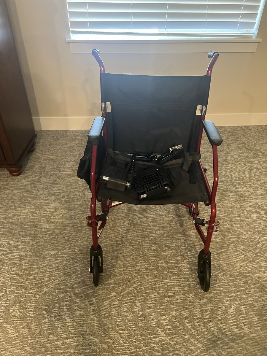Red Lightweight Transport Wheelchair with Footrests and Storage Pouch