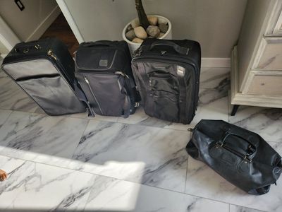 Tumi and Coach luggage carry on size