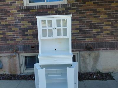 White cabinet with folding shelves.