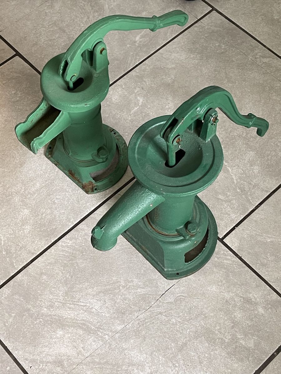 These are old cast-iron hand water pumps