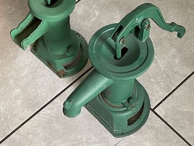 These are old cast-iron hand water pumps