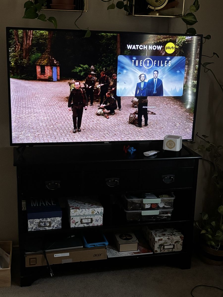 onn. Smart TV with black TV stand