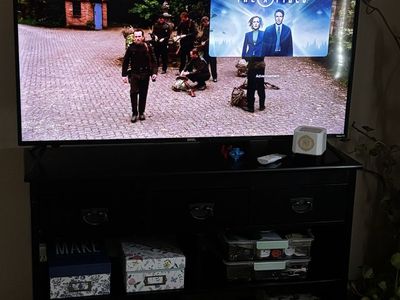 onn. Smart TV with black TV stand