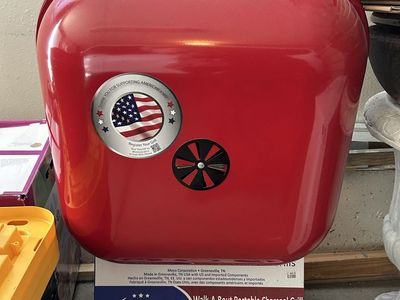 New- never used Portable Grill + 2 bags Charcoal