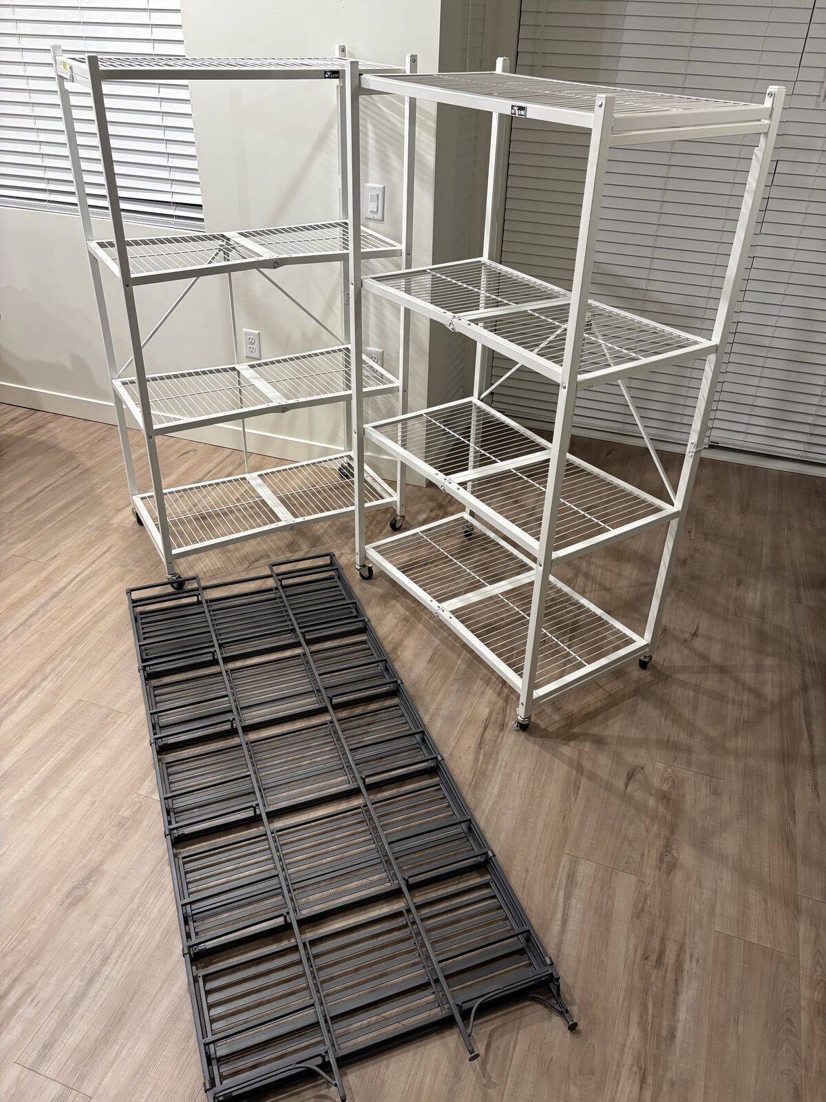 Two origami folding shelves and a folding iron bookshelf - $200