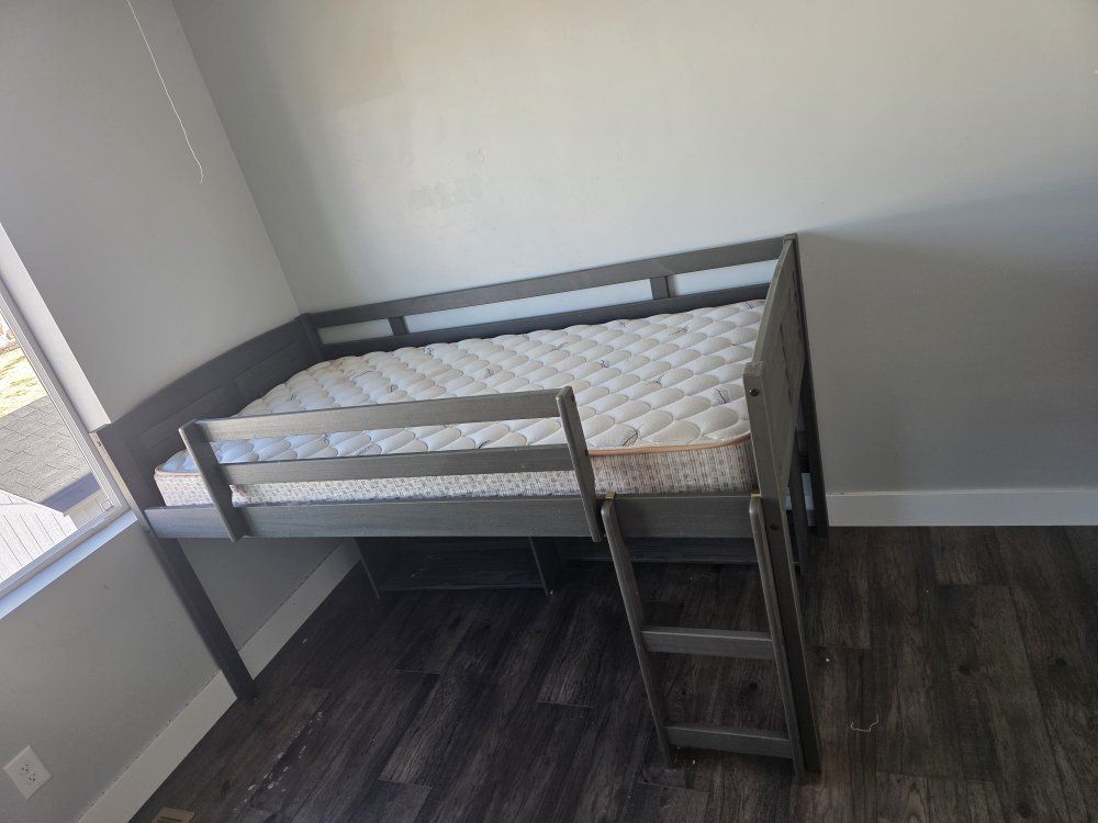 Toddler bed and play area with shelves