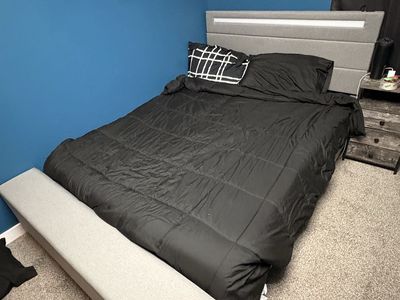 Adjustable bed frame with LED head board and a storage