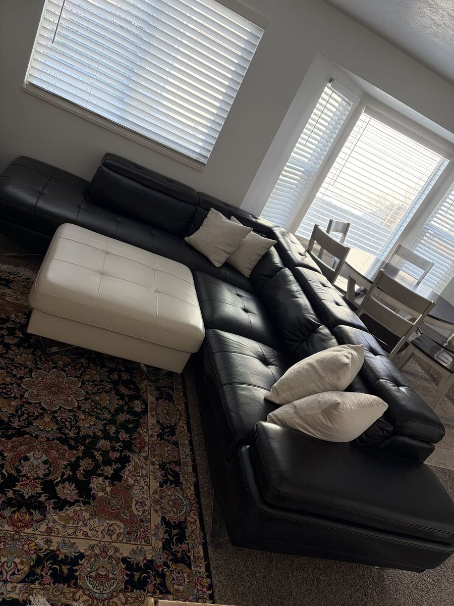 Black Leather Sectional and White Coffee Table/ Foot Rest