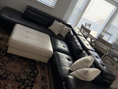 Black Leather Sectional and White Coffee Table/ Foot Rest