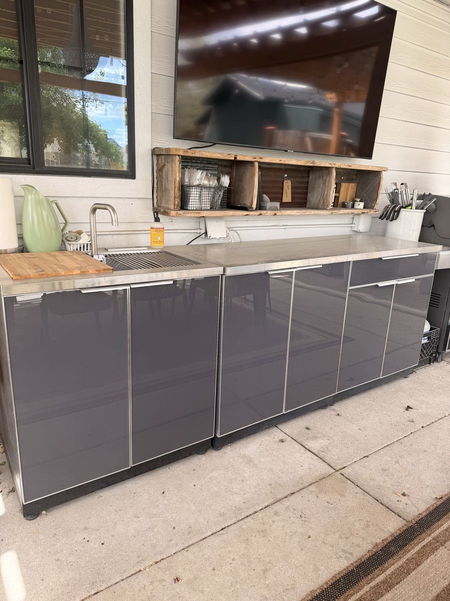 Outdoor kitchen with sink and stainless steel countertops