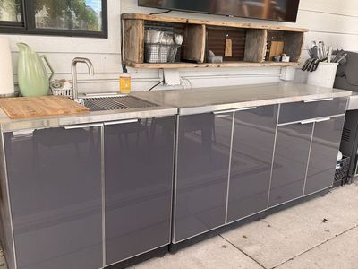 Outdoor kitchen with sink and stainless steel countertops