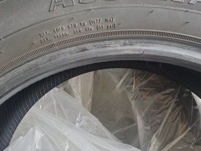 Two Goodyear Assurance Maxlife 215/55R17 94V all-season high mileage touring tires.