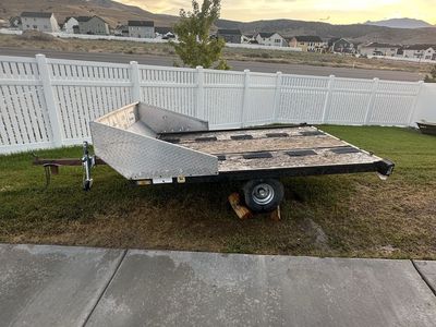 Tilt bed utility / snowmobile trailer.