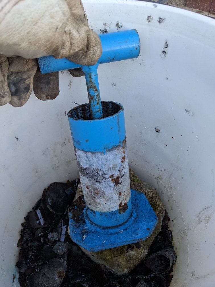 Glass crusher with bucket of mostly broken glass