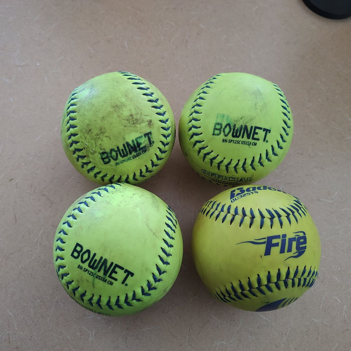 4 used softballs