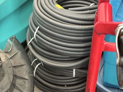 Large Coil of Gray Electrical Conduit - Flexible Plastic Tubing for Wiring Projects