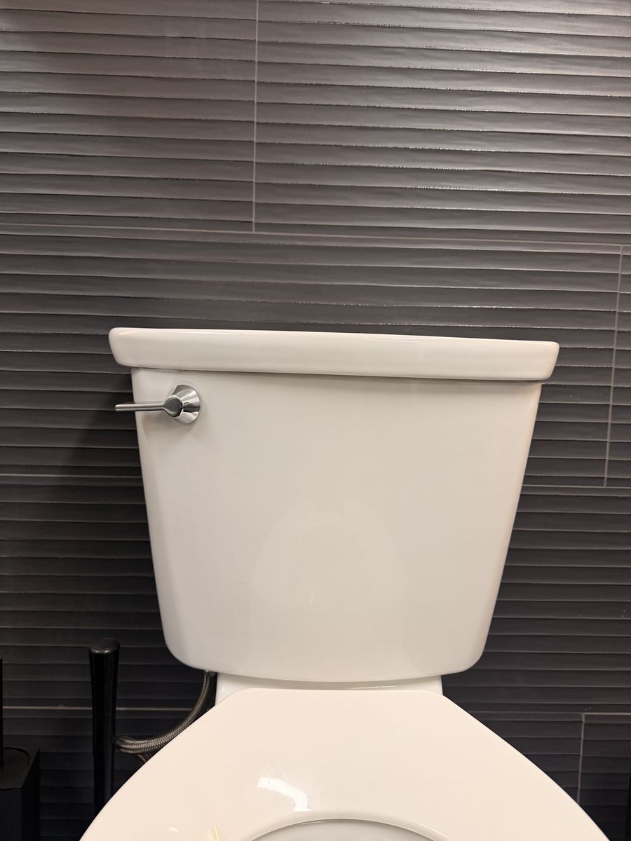 Left handed toilet tank