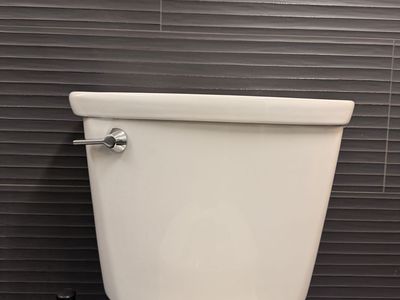 Left handed toilet tank