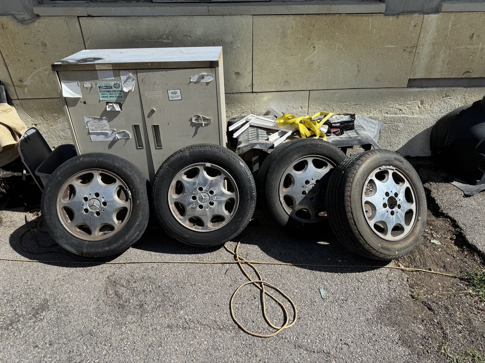 Four 15-inch OEM rims and tires from 1994 Mercedes E-Class. $75 OBO