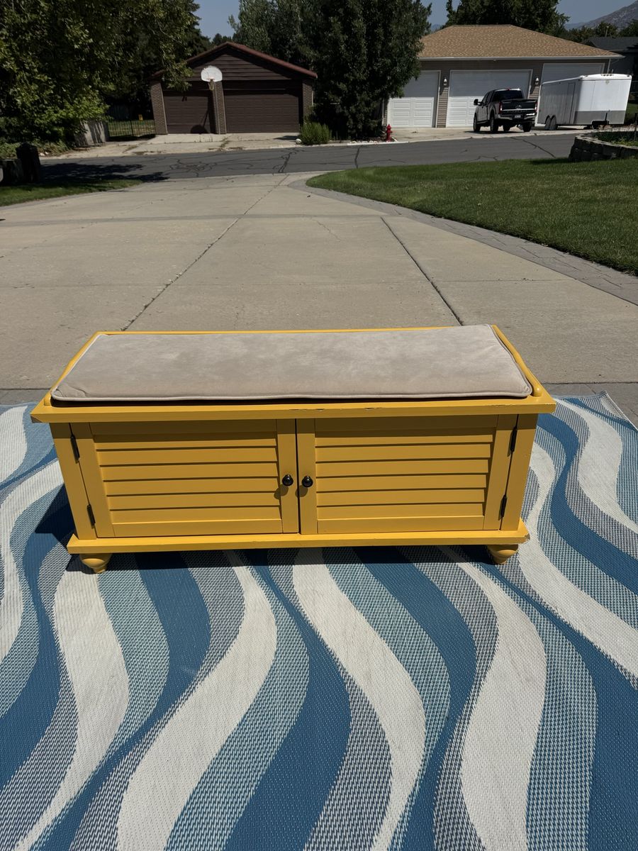 Yellow Storage Bench with Dual Cabinet Doors and Beige Cushion