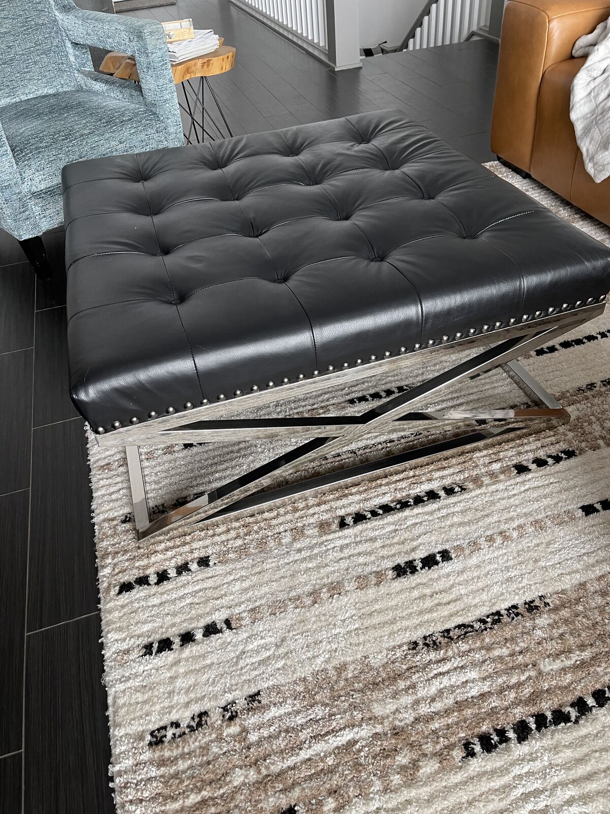 Black leather tufted ottoman