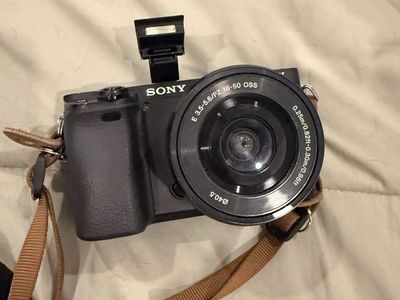 Sony Alpha Mirrorless Camera with 16-50mm PZ OSS Lens and Brown Strap