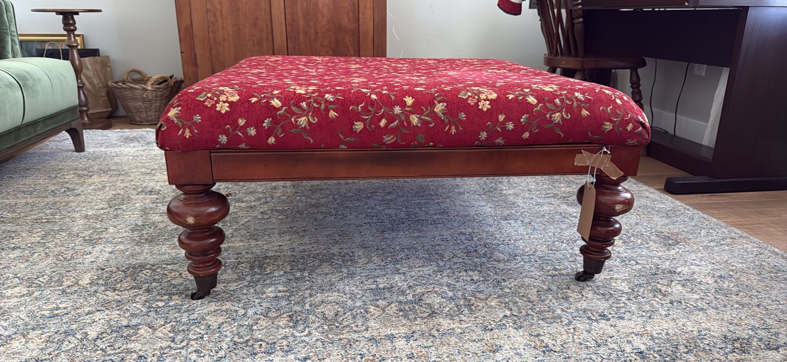 Antique Victorian era style ottoman on risers with cute spindle legs.