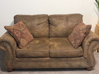Brown Leather Loveseat and Chair with Nailhead Trim and Patterned Accent Pillows