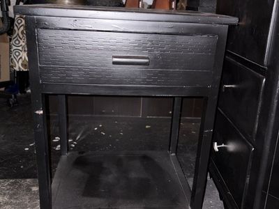 Black Wooden Nightstand with Textured Drawer Front and Lower Shelf