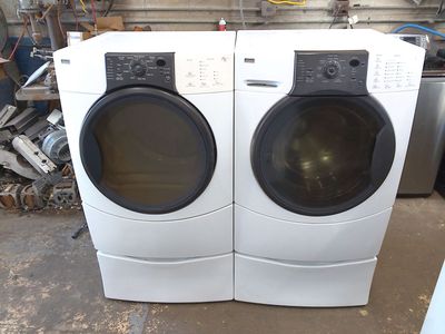 Kenmore Elite front load washer with matched electric dryer on pedestals
