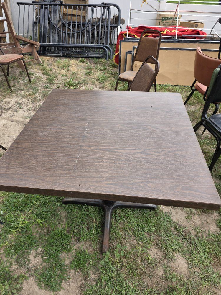 5 restaurant tables and some chairs.