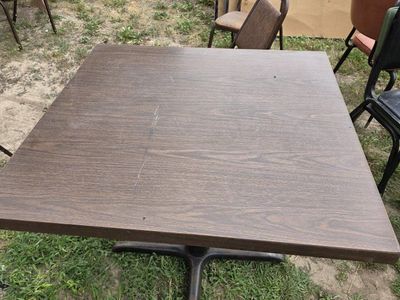 5 restaurant tables and some chairs.
