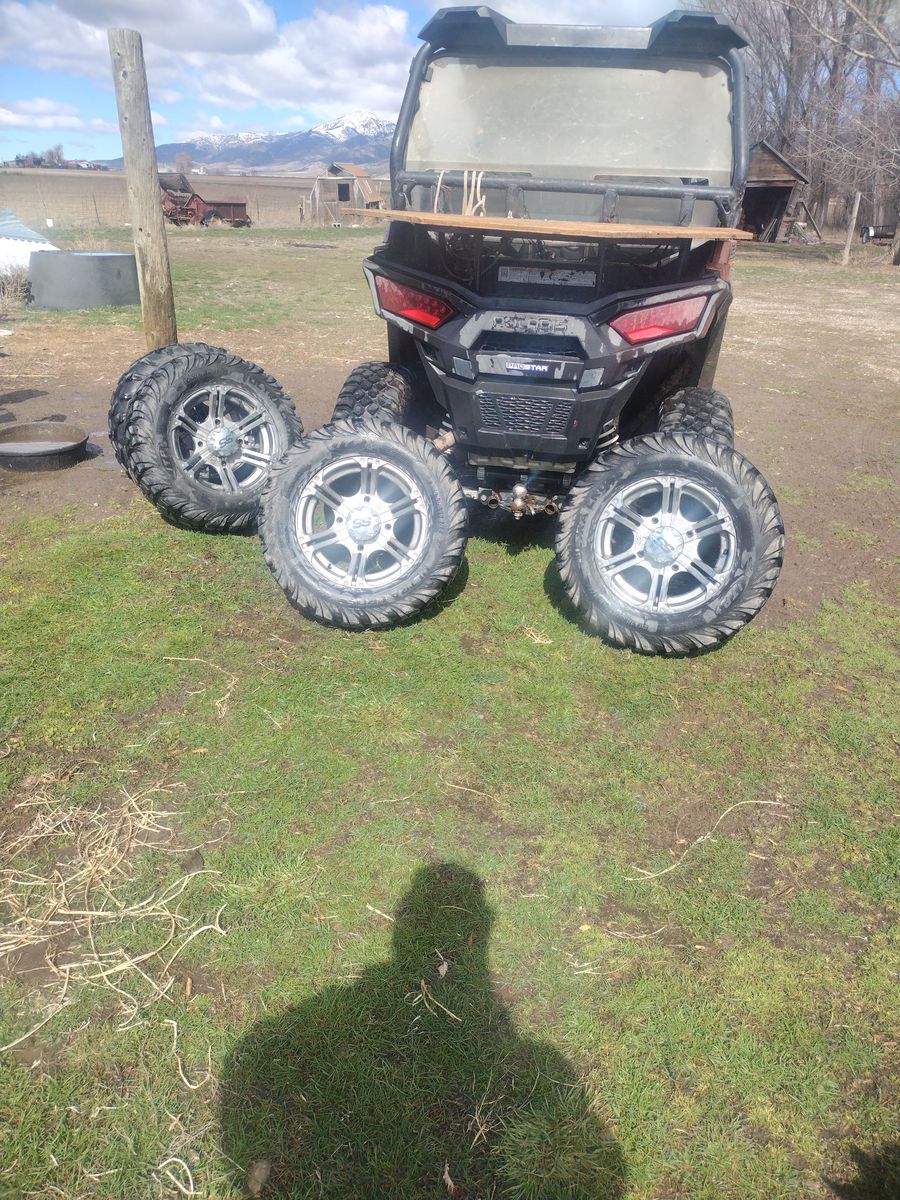 FOUR USED 10.00/26/75R WHEELS WITH TIRES