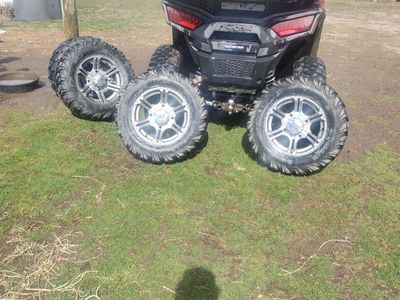 FOUR USED 10.00/26/75R WHEELS WITH TIRES