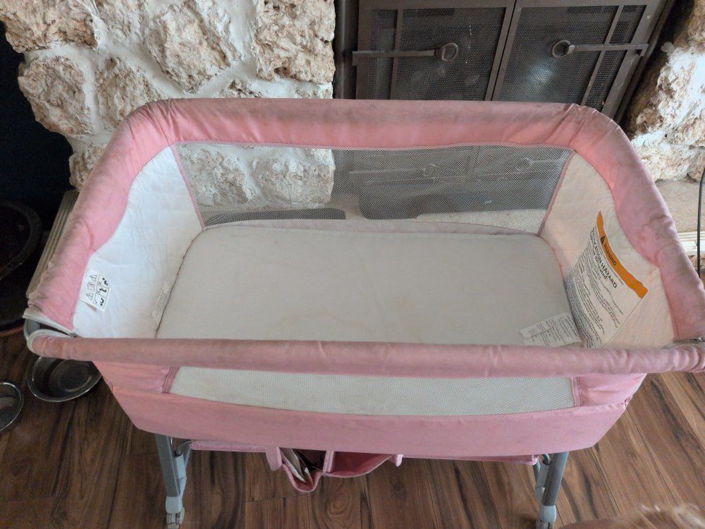 Pink Bedside Bassinet with Adjustable Height and Storage Basket