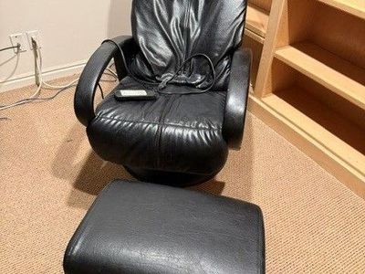 Black Leather Brookstone Stationary Massage chair with foot stool.