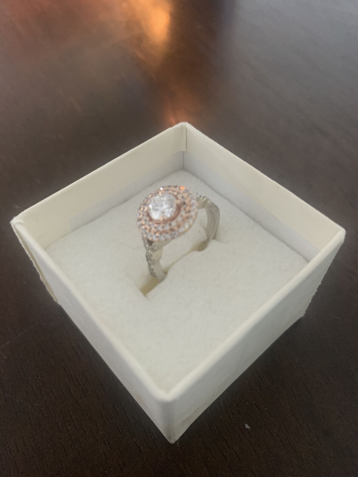 Halo style engagement ring w/ rose gold