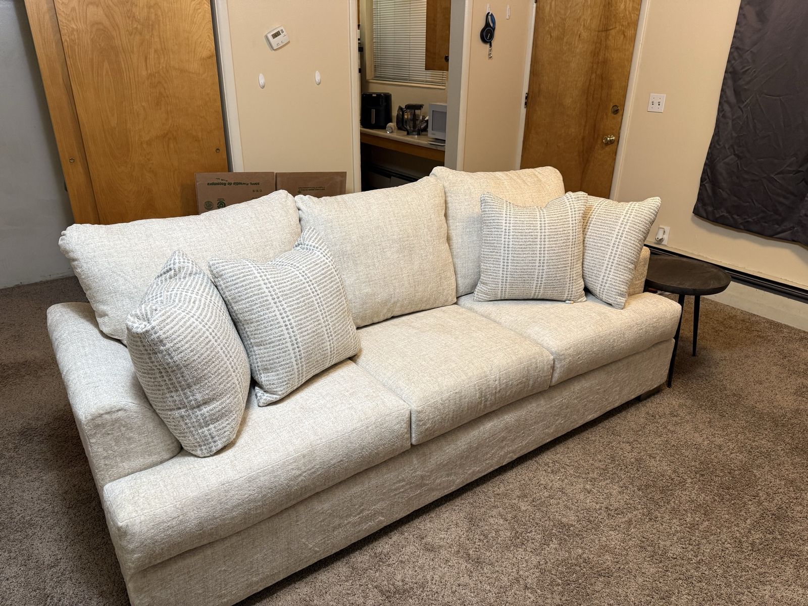 Couch | Modern Light Beige Three-Seater Sofa with Patterned Throw Pillows