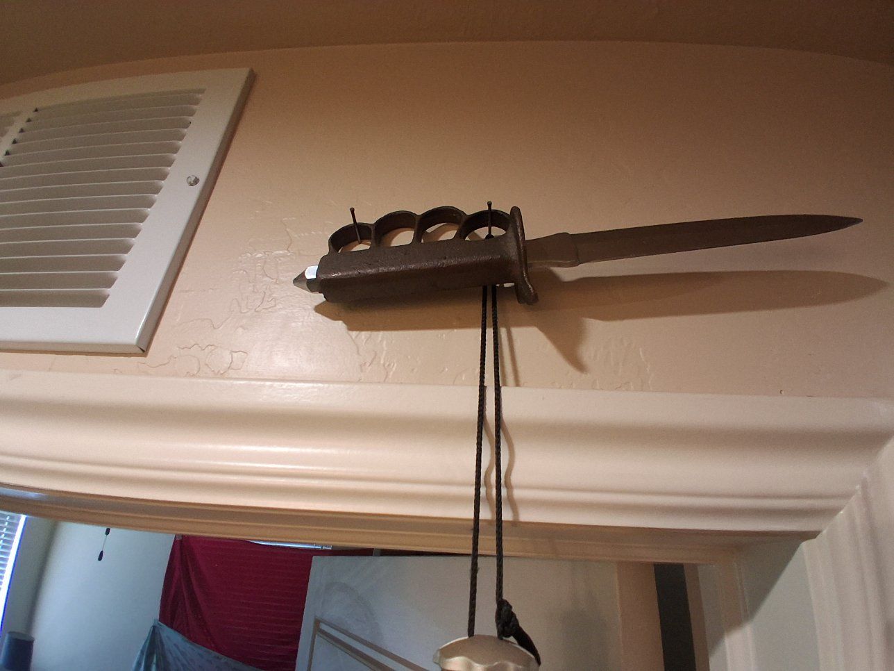 The item mounted on the wall is a U.S. Model 1918 Mark I Trench Knife. This iconic combat weapon was developed for hand-to-hand