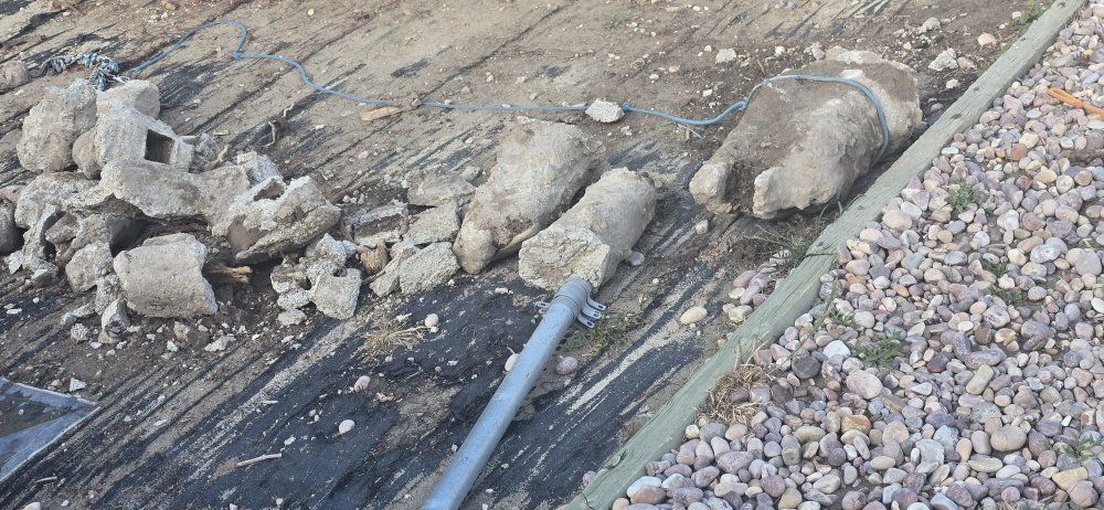 broken cement and metal pole