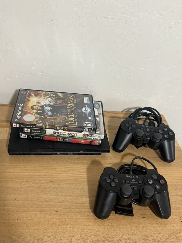 PlayStation 2 slim w /two controllers n 3 games