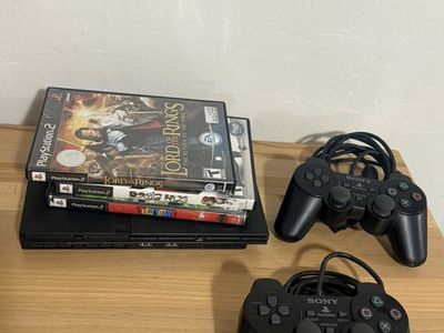 PlayStation 2 slim w /two controllers n 3 games